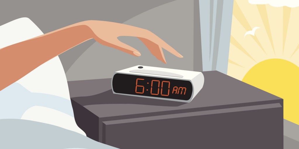 Person turning off alarm clock